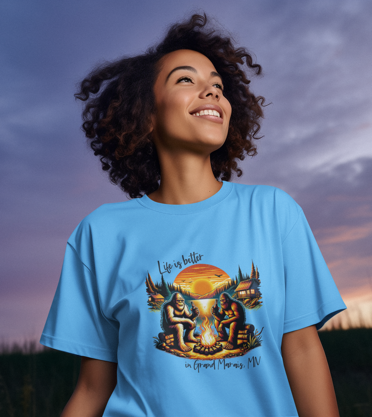 Life is better in...YOUR LOCATION - Bigfoot campfire shirt: Carolina blue / 4X